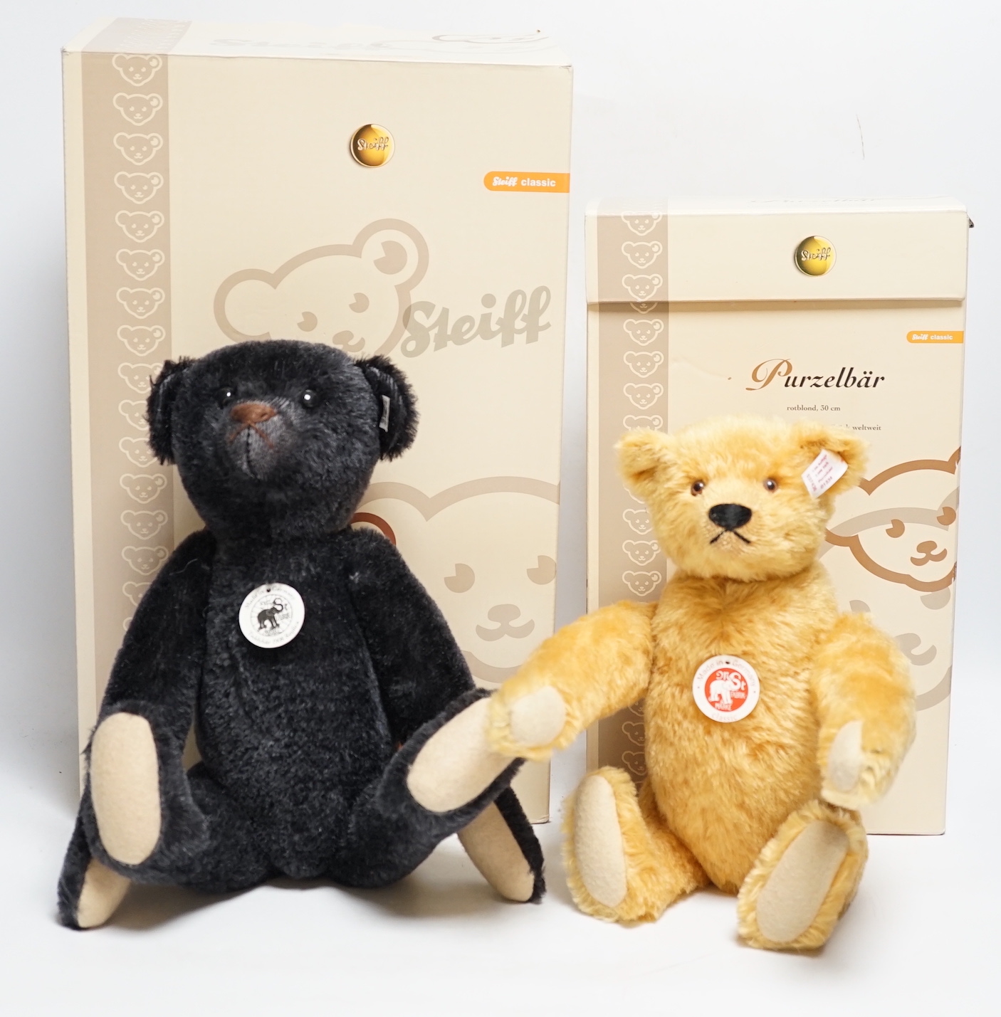 A blond Steiff somersaulting Teddy bear and a Steiff replica 1908 black Teddy bear, each boxed with certificate